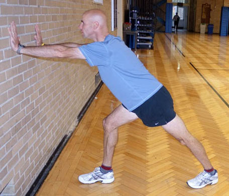 Dan Kehlenbach demonstrating achilles stretch for bicycle riders