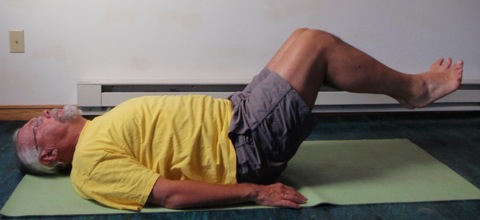 Coach John Hughes demonstrating bent two leg raise exercise for core training for cycling
