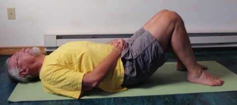 Coach John Hughes demonstrating bridging exercise for core training for cyclists