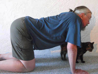 John Hughes demonstrating the cat stretch for bicycle riders