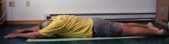 Coach John Hughes demonstrating the lying back extension exercise for core training for cyclists