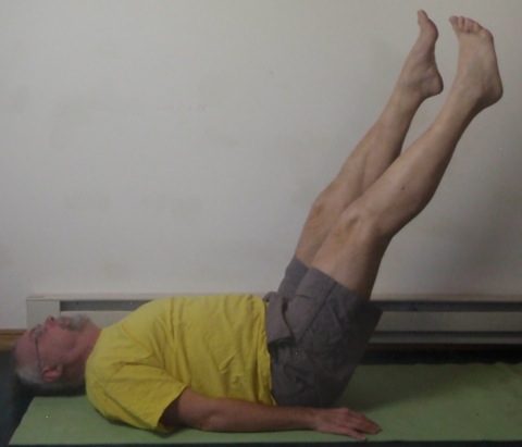 Coach John Hughes demonstrating Pilates circles exercise for core training for cycling